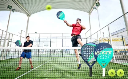 The IANONI PR8500 Padel Racket being used by a man on a padel court as he hits a volley while jumping.